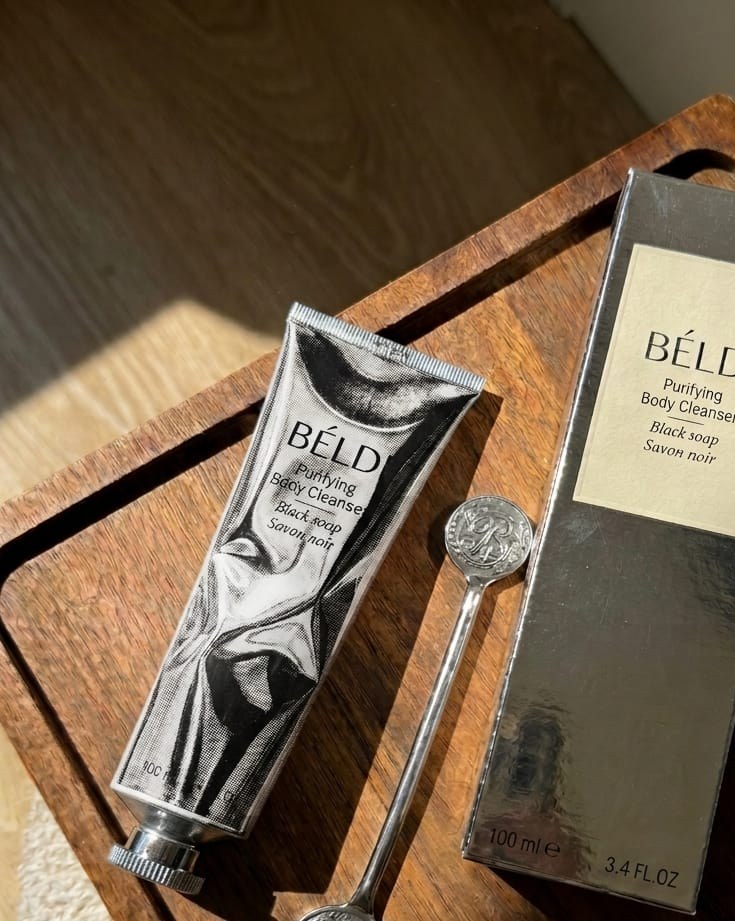 The BÉLDI tube, its box and the monogrammed key on a dark wooden tray